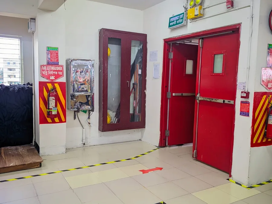 Marked Emergency Exit with Fire Extinguisher and PPE Cabinet